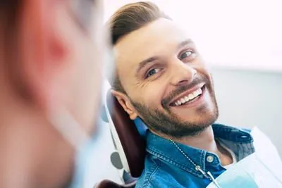 man happy with his smile after getting his teeth whitened at Gina Biedermann DDS in Keller, TX