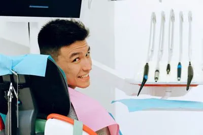 man smiling in the dental chair during his dental appointment