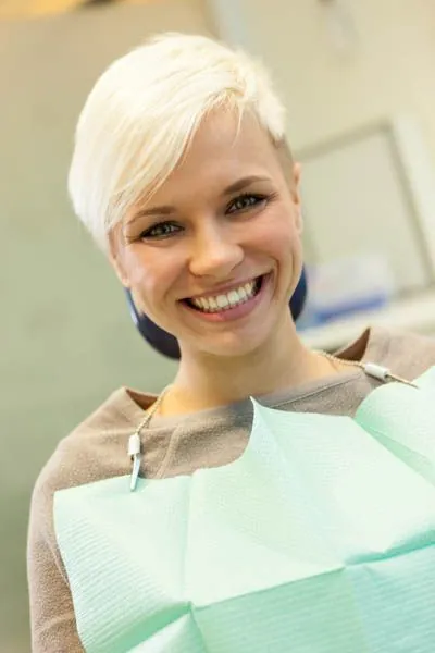 woman smiling during her dental appointment at Gina Biedermann DDS in Keller, TX