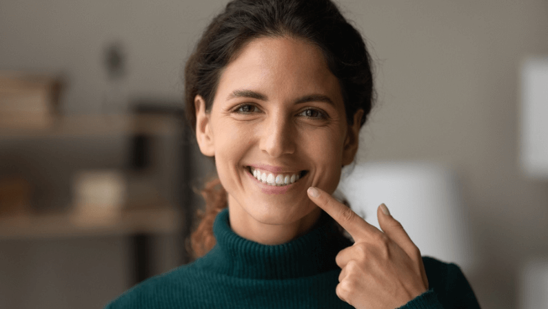 Shiny smile. Portrait of young happy hispanic woman satisfied patient of dental clinic. Millennial lady enjoy perfect result of orthodontic care procedures look at