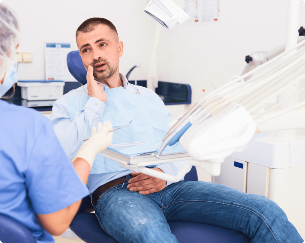 Concerned man consults a dentist about a troubling toothache
