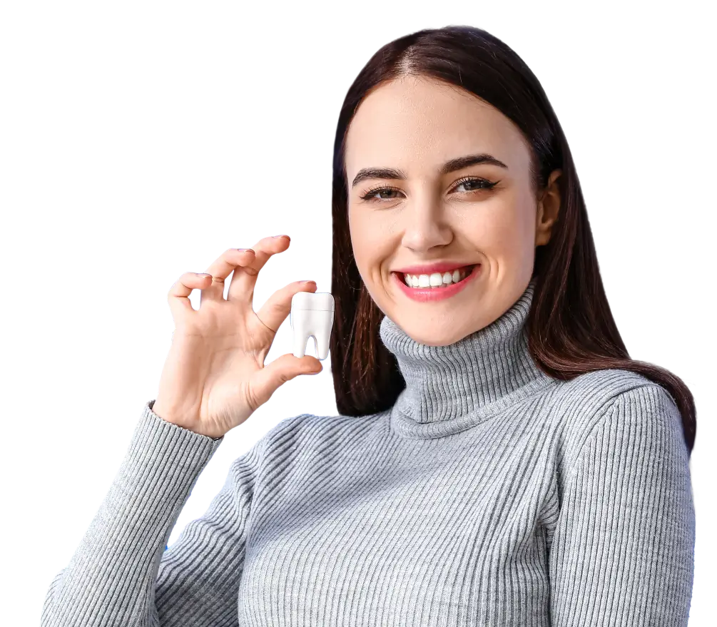 woman smiling holding a dental tooth model