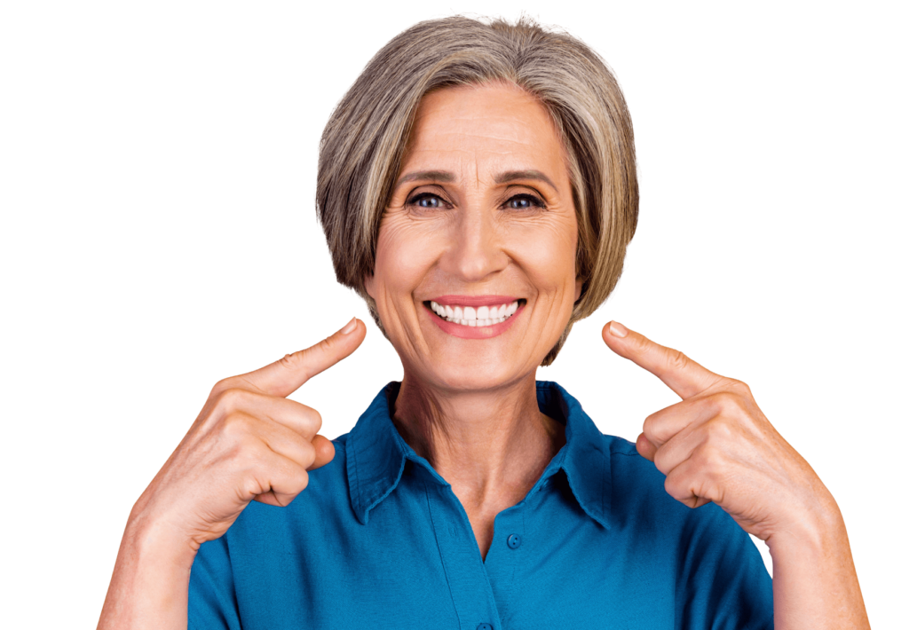 Smiling senior woman pointing to her healthy teeth