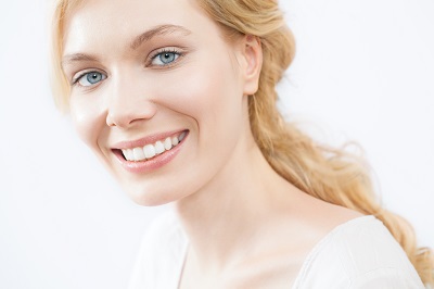 Smiling blonde woman with bright white teeth exudes confidence.